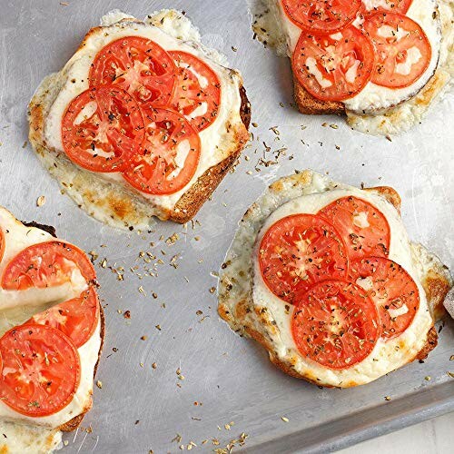 Baked toast with melted cheese and sliced tomatoes on a tray.