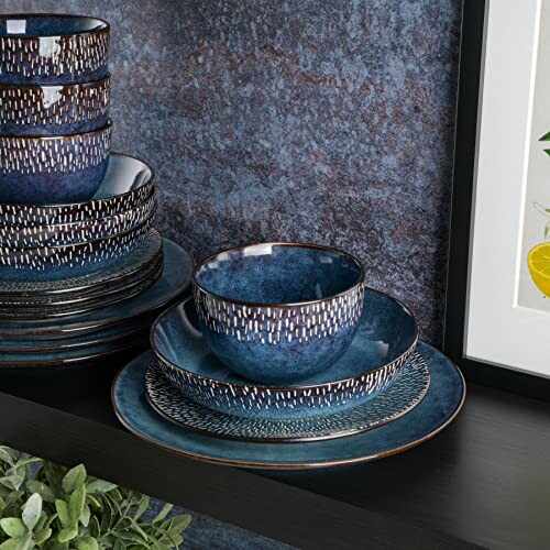 Blue ceramic dinnerware set with bowls and plates on a shelf