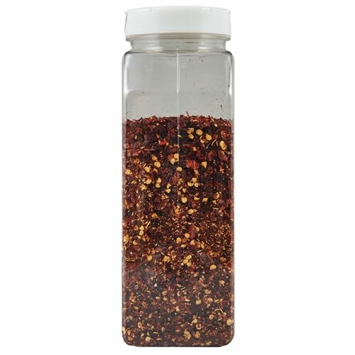 Clear plastic jar filled with red chili flakes.