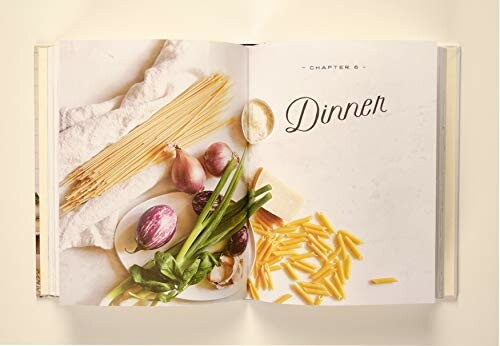 Open cookbook with Dinner chapter and ingredients like pasta, onions, and cheese.