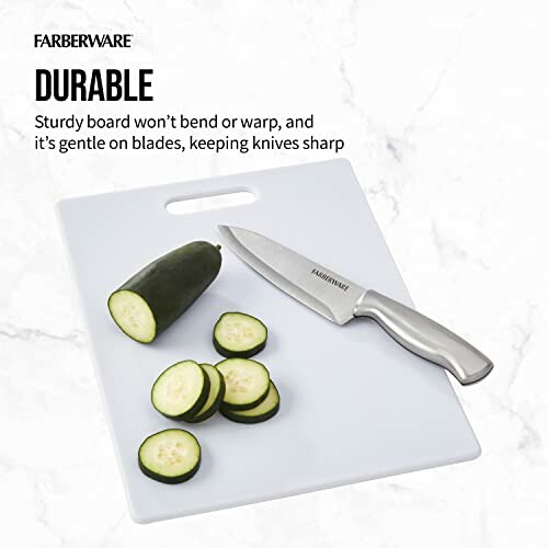 Cutting board with knife and sliced cucumber.