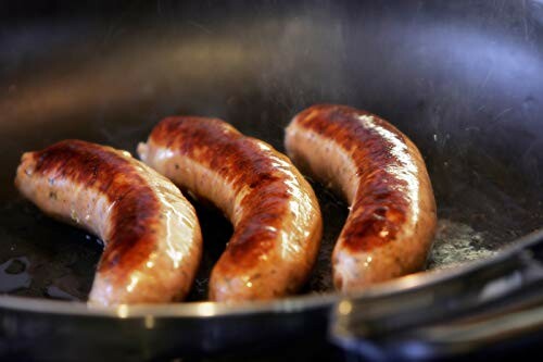 Three grilled sausages in a pan.