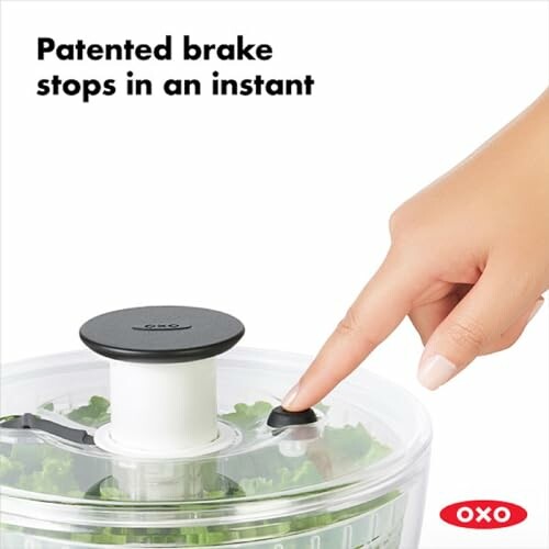 Finger pressing brake on OXO salad spinner.